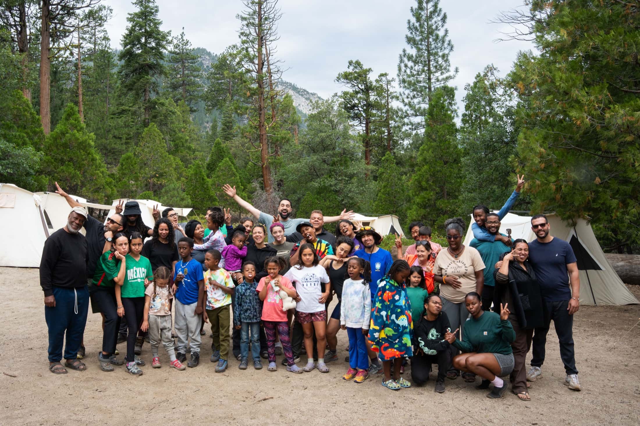 The full Outdoorithm group, about forty five adults and children, in front of the canvas tent village