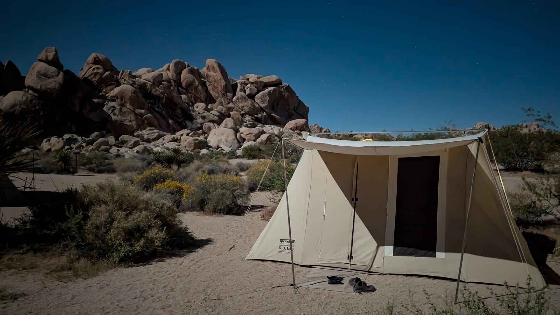 Springbar canvas tent at night under stars in the desert